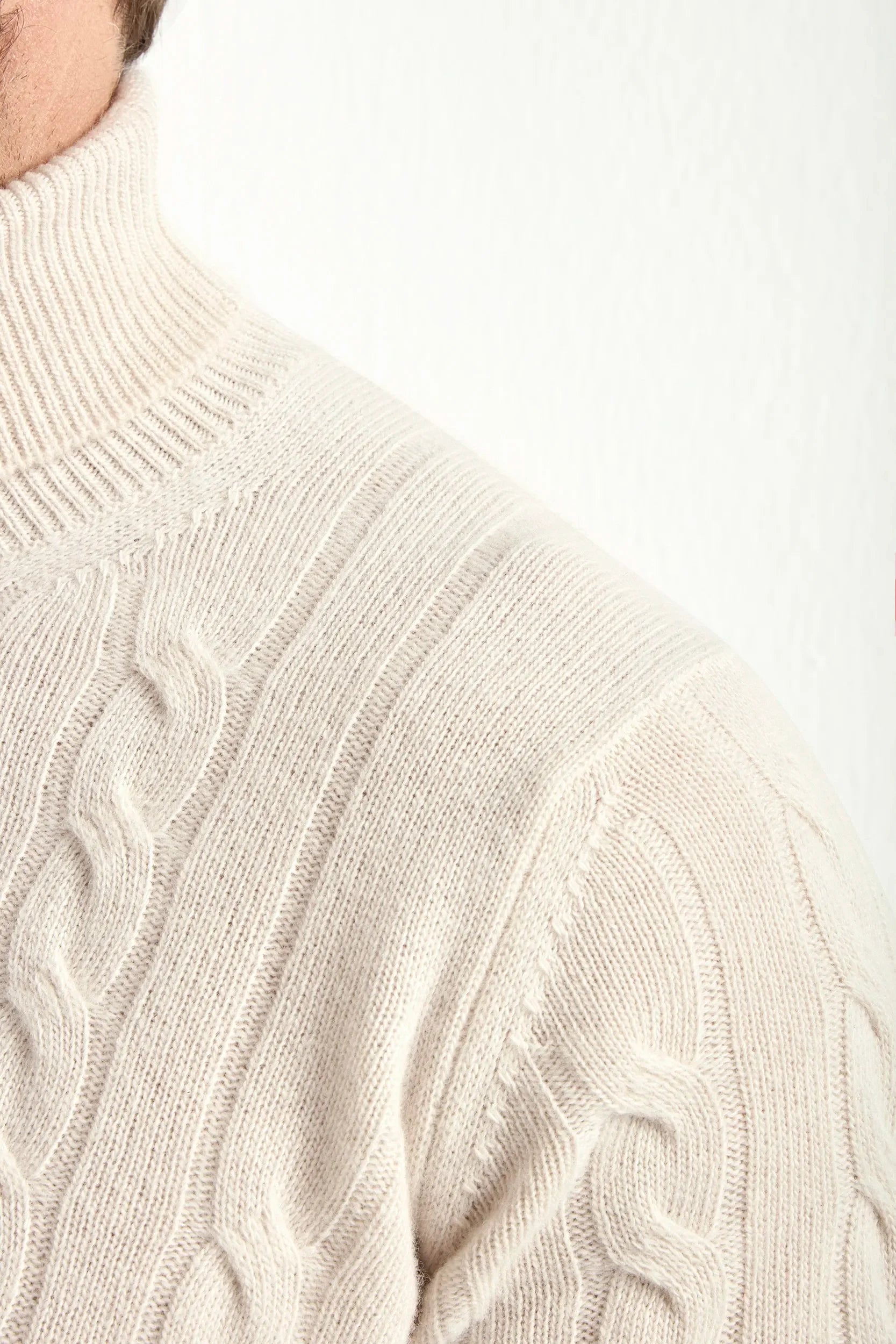 Beige cable-knit turtleneck sweater